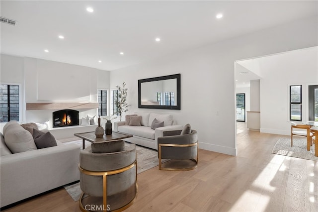26065 Charing Cross Rd, Valencia, CA 91355 - living room featuring light wood-style floors, plenty of natural light, recessed lighting, and a lit fireplace
