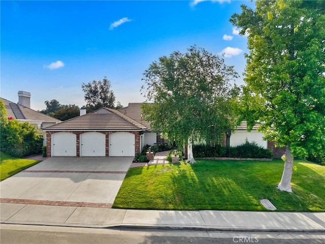 26065 Charing Cross Rd, Valencia, CA 91355 - view of front of home featuring an attached garage, concrete driveway, a front lawn, and a tile roof