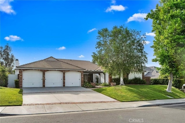 26065 Charing Cross Rd, Valencia, CA 91355 - view of front of property featuring an attached garage, driveway, a front yard, a tiled roof, and a chimney