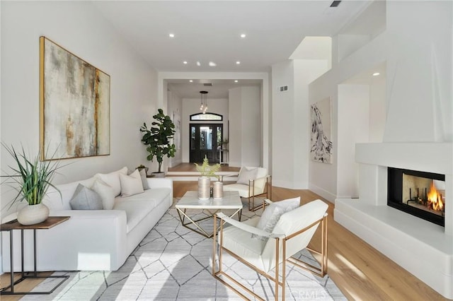 26065 Charing Cross Rd, Valencia, CA 91355 - living area with light wood-style flooring, a fireplace, recessed lighting, and baseboards