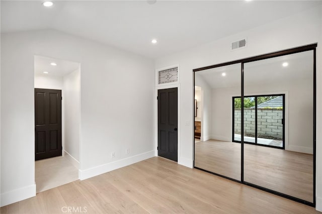 26065 Charing Cross Rd, Valencia, CA 91355 - unfurnished bedroom featuring vaulted ceiling, light wood-style flooring, recessed lighting, baseboards, and access to exterior