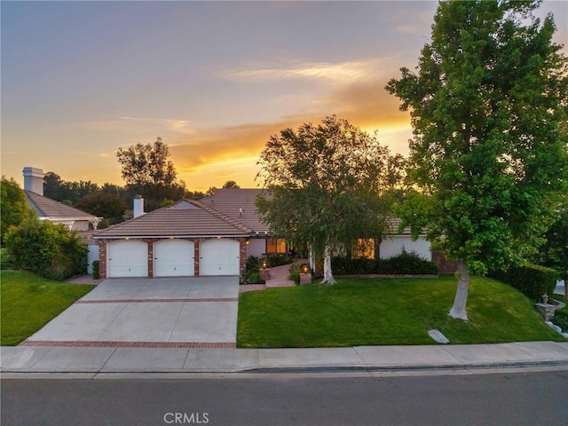 26065 Charing Cross Rd, Valencia, CA 91355 - view of front of house with a garage, driveway, a front yard, and a tile roof