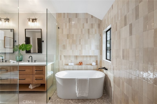26065 Charing Cross Rd, Valencia, CA 91355 - full bath with tile walls, a freestanding tub, vanity, tile patterned flooring, and vaulted ceiling