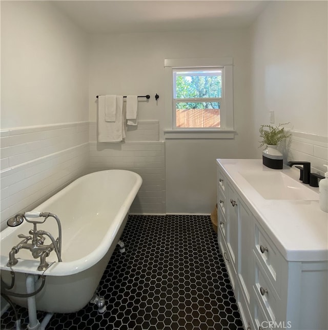 3222 E 10th St, Long Beach, CA 90804 - bathroom featuring tile walls, a freestanding bath, a wainscoted wall, and vanity