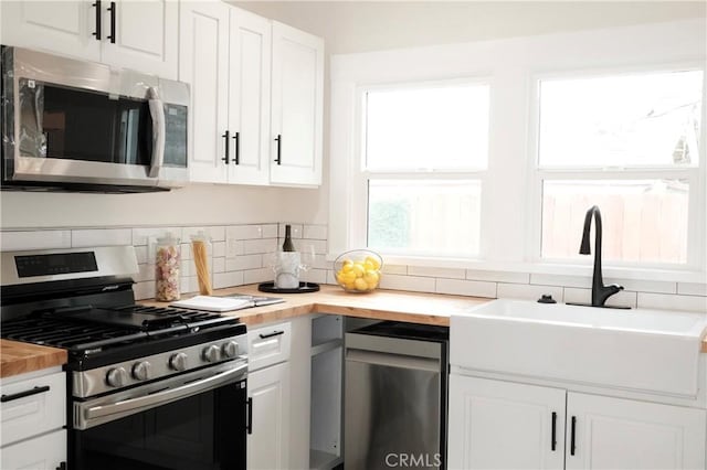 3222 E 10th St, Long Beach, CA 90804 - kitchen featuring stainless steel appliances, butcher block countertops, a sink, and backsplash