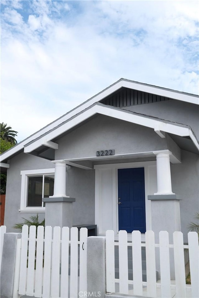 3222 E 10th St, Long Beach, CA 90804 - view of front of house featuring stucco siding and a fenced front yard