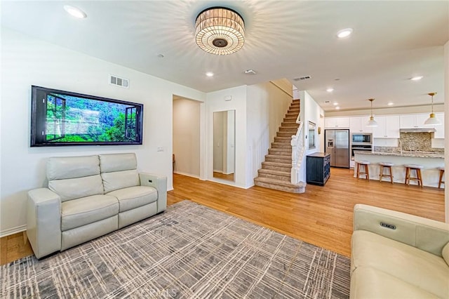 24207 Via Perla, Valencia, CA 91354 - living area with stairs, light wood-style floors, baseboards, and recessed lighting