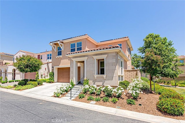 24207 Via Perla, Valencia, CA 91354 - mediterranean / spanish house featuring concrete driveway, a garage, a tile roof, and stucco siding