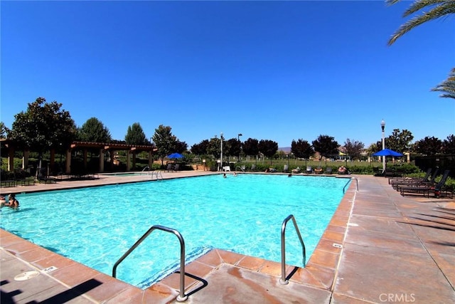24207 Via Perla, Valencia, CA 91354 - community pool with a pergola and a patio area