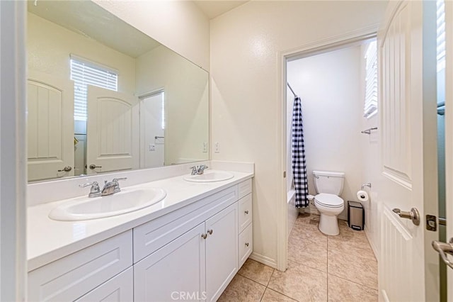 24207 Via Perla, Valencia, CA 91354 - bathroom featuring double vanity, toilet, plenty of natural light, and tile patterned floors