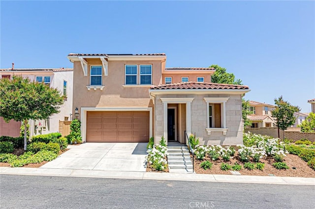 24207 Via Perla, Valencia, CA 91354 - mediterranean / spanish-style home with driveway, stucco siding, a garage, a tile roof, and stone siding