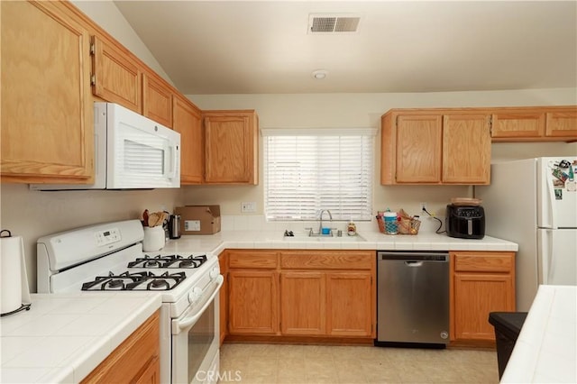 11017 Tipperary Dr, Bakersfield, CA 93311 - kitchen with white appliances, a sink, and tile countertops