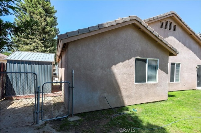 11017 Tipperary Dr, Bakersfield, CA 93311 - view of property exterior featuring stucco siding, a gate, and an outdoor structure