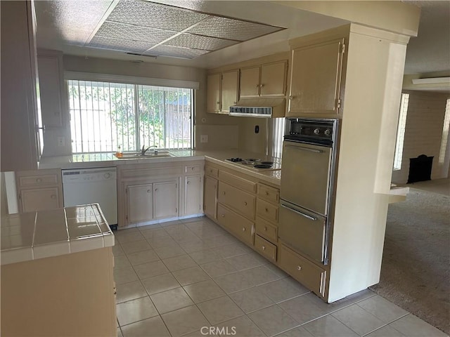 2915 El Camino Real, Merced, CA 95340 - kitchen with white dishwasher, tile counters, light tile patterned flooring, electric cooktop, and a sink