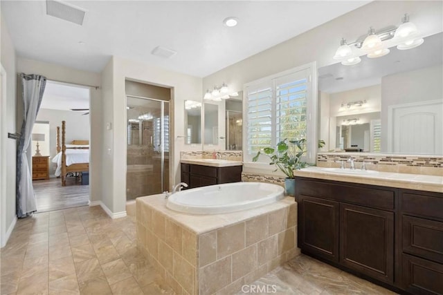 45976 Camino Rubi, Temecula, CA 92592 - bathroom with a shower stall, two vanities, connected bathroom, a garden tub, and decorative backsplash