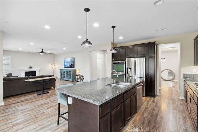 45976 Camino Rubi, Temecula, CA 92592 - kitchen featuring a sink, light wood-style floors, stainless steel appliances, ceiling fan, and recessed lighting
