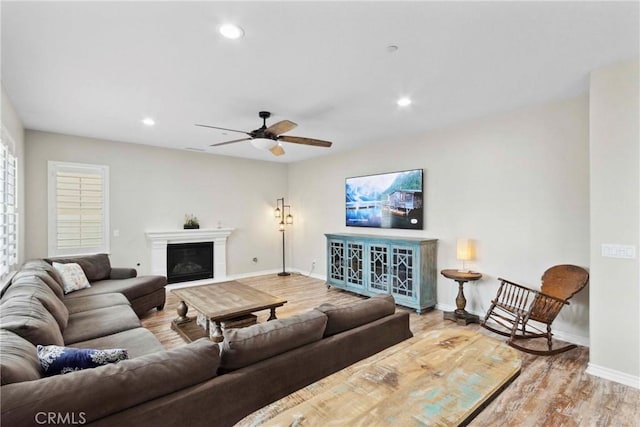 45976 Camino Rubi, Temecula, CA 92592 - living room with wood finished floors, baseboards, ceiling fan, a glass covered fireplace, and recessed lighting