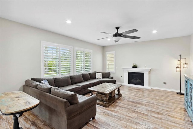 45976 Camino Rubi, Temecula, CA 92592 - living area featuring light wood-style floors, recessed lighting, a ceiling fan, baseboards, and a glass covered fireplace