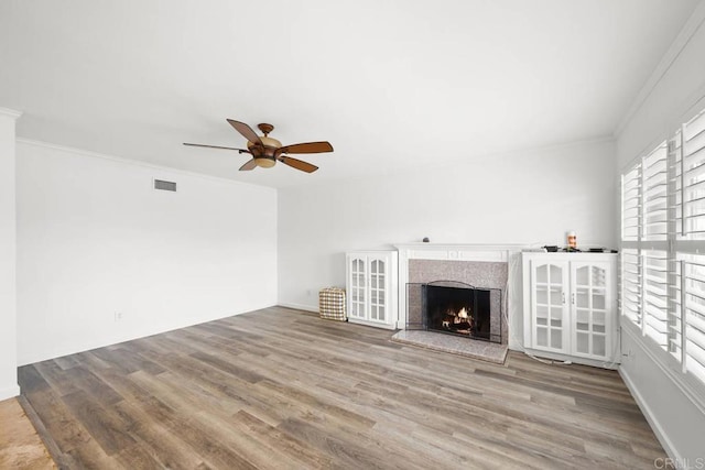 3999 Arey Dr, San Diego, CA 92154 - unfurnished living room featuring plenty of natural light, crown molding, a ceiling fan, wood finished floors, and a premium fireplace