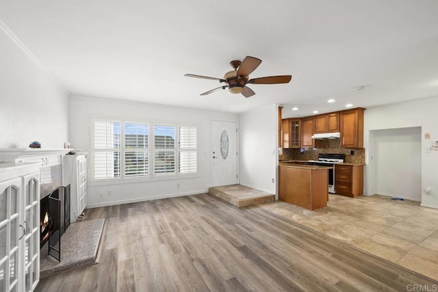 3999 Arey Dr, San Diego, CA 92154 - unfurnished living room featuring baseboards, ceiling fan, recessed lighting, light wood-style floors, and a warm lit fireplace
