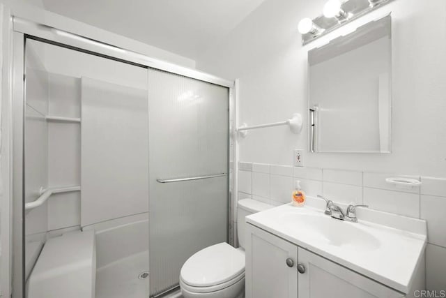 3999 Arey Dr, San Diego, CA 92154 - full bathroom with a shower stall, toilet, vanity, and tile walls