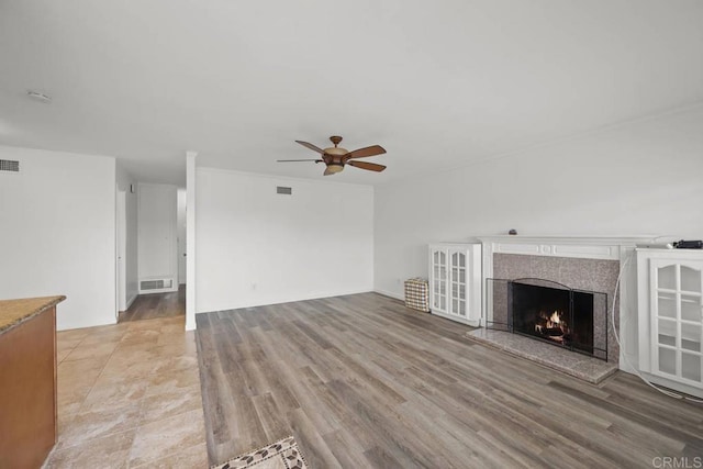 3999 Arey Dr, San Diego, CA 92154 - unfurnished living room featuring a ceiling fan, a fireplace, and light wood finished floors
