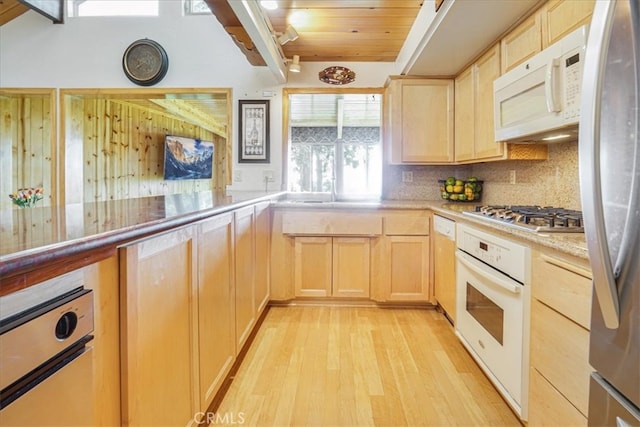 1954 Nob Hill Dr, Running Springs, CA 92382 - kitchen featuring light brown cabinetry, stainless steel appliances, light wood-style flooring, decorative backsplash, and wood ceiling