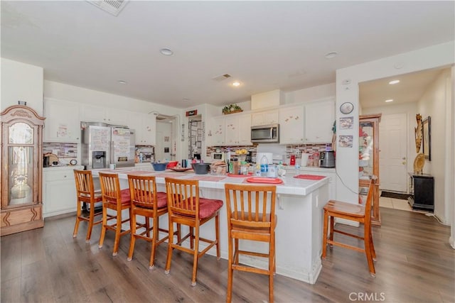 6810 Evans St, Palmdale, CA 93552 - kitchen with stainless steel appliances, white cabinetry, light countertops, tasteful backsplash, and recessed lighting