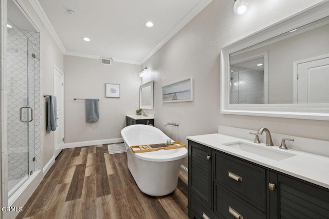 1503 Windshore Way, Oxnard, CA 93035 - bathroom with a stall shower, wood finished floors, a freestanding bath, two vanities, and crown molding