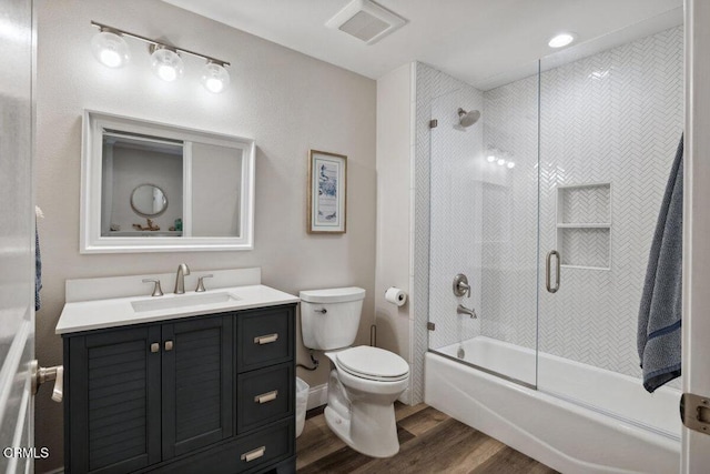 1503 Windshore Way, Oxnard, CA 93035 - bathroom featuring wood finished floors, vanity, toilet, and shower / bath combination with glass door