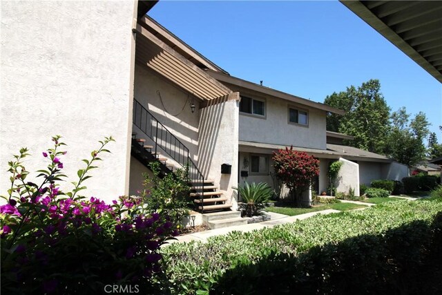 245 Doverfield Dr Unit 46, Placentia, CA 92870 - back of property with stairs and stucco siding