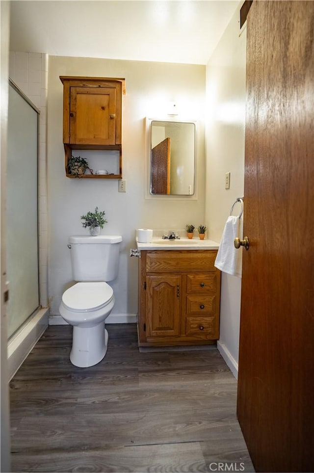 10655 Banner Lava Cap Rd, Nevada City, CA 95959 - bathroom featuring vanity, toilet, baseboards, a stall shower, and wood finished floors