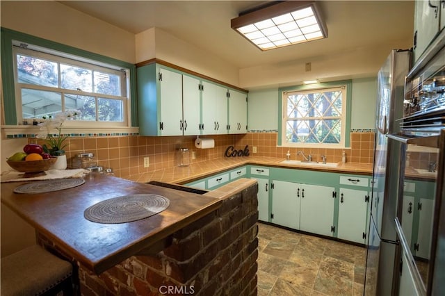 10655 Banner Lava Cap Rd, Nevada City, CA 95959 - kitchen with a sink, healthy amount of natural light, tasteful backsplash, and stone finish flooring