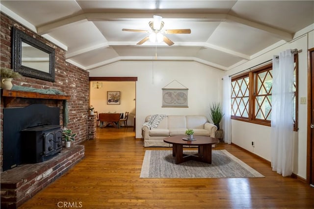 10655 Banner Lava Cap Rd, Nevada City, CA 95959 - living room with a ceiling fan, a wood stove, vaulted ceiling, wood finished floors, and baseboards