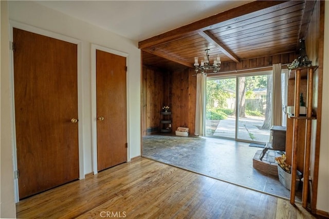 10655 Banner Lava Cap Rd, Nevada City, CA 95959 - interior space with a chandelier, wood finished floors, wood walls, a wood stove, and wood ceiling with exposed beams