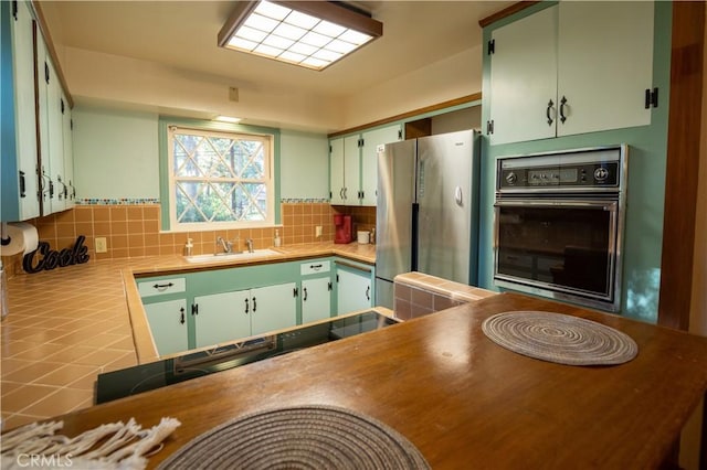 10655 Banner Lava Cap Rd, Nevada City, CA 95959 - kitchen with black appliances, tasteful backsplash, a sink, and tile counters