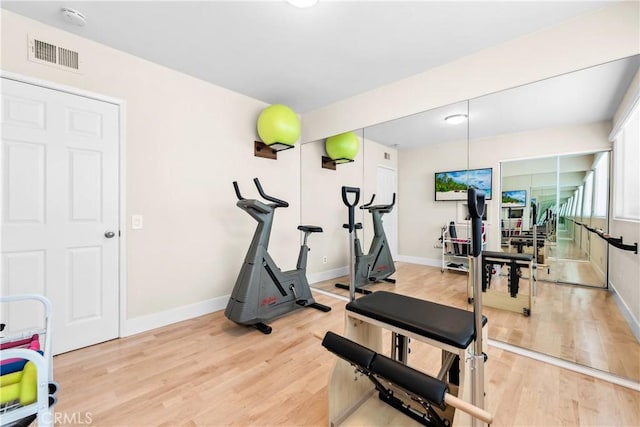 18743 Club Ln, Huntington Beach, CA 92648 - workout area with baseboards and light wood-style floors