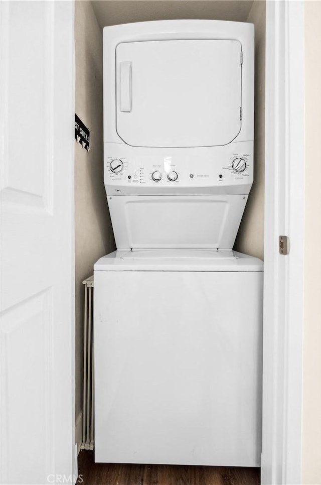 18743 Club Ln, Huntington Beach, CA 92648 - laundry area featuring estacked washer and dryer and dark wood-style floors