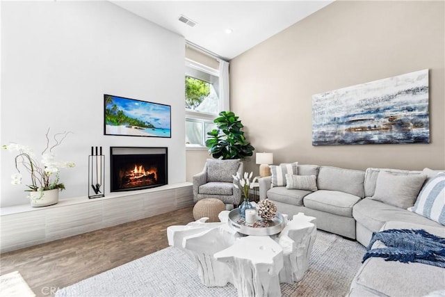 18743 Club Ln, Huntington Beach, CA 92648 - living area with a warm lit fireplace, wood finished floors, and lofted ceiling