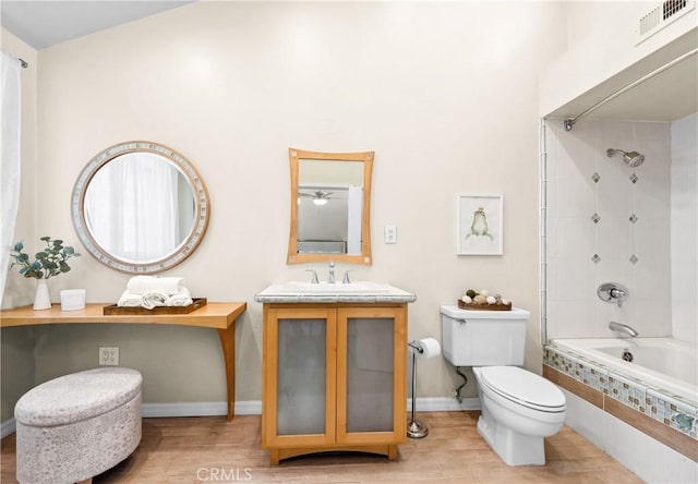 18743 Club Ln, Huntington Beach, CA 92648 - full bath featuring tiled shower / bath, toilet, wood finished floors, and vanity