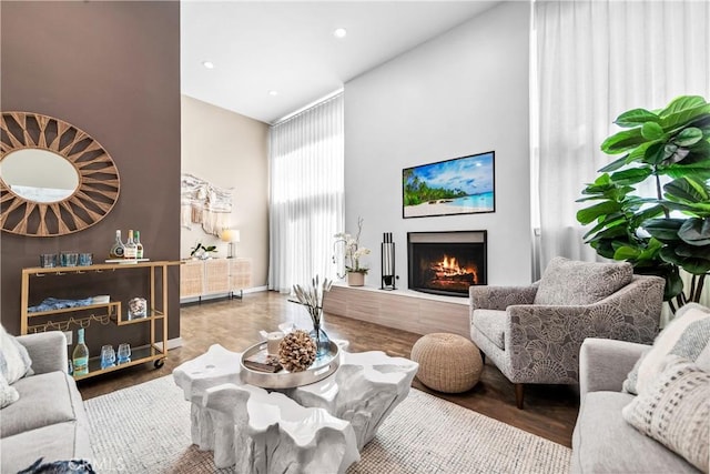 18743 Club Ln, Huntington Beach, CA 92648 - living area with a high ceiling, a lit fireplace, wood finished floors, and recessed lighting