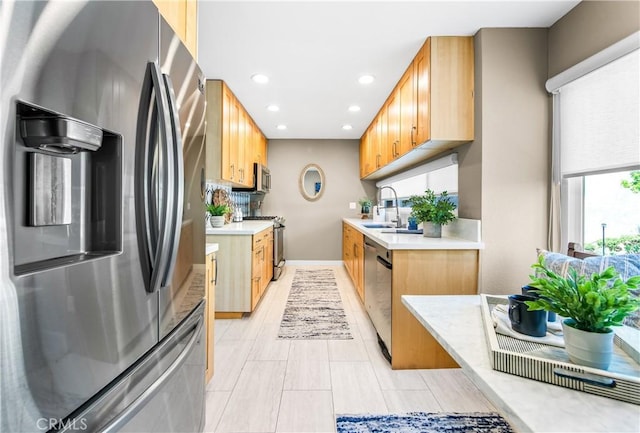 18743 Club Ln, Huntington Beach, CA 92648 - kitchen featuring stainless steel appliances, light countertops, a sink, recessed lighting, and baseboards