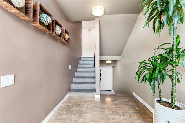 18743 Club Ln, Huntington Beach, CA 92648 - stairs with wood finished floors, baseboards, and vaulted ceiling