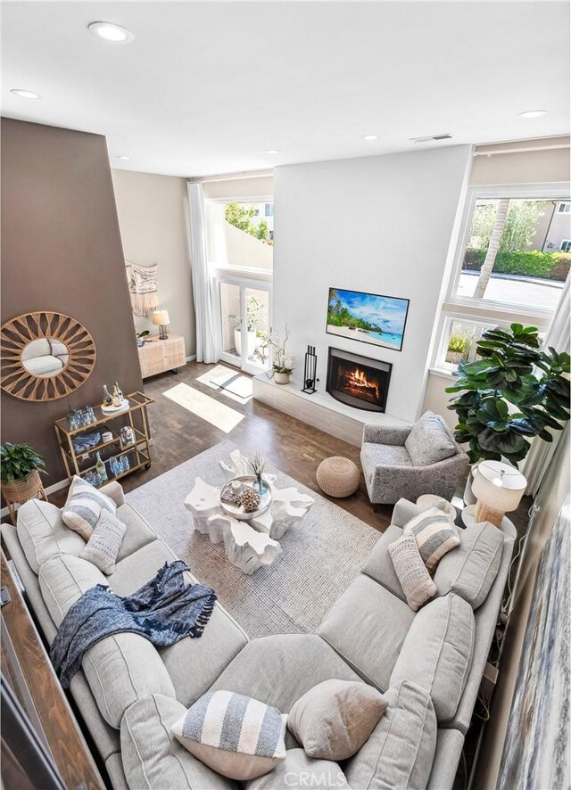 18743 Club Ln, Huntington Beach, CA 92648 - living area with wood finished floors, a lit fireplace, and recessed lighting