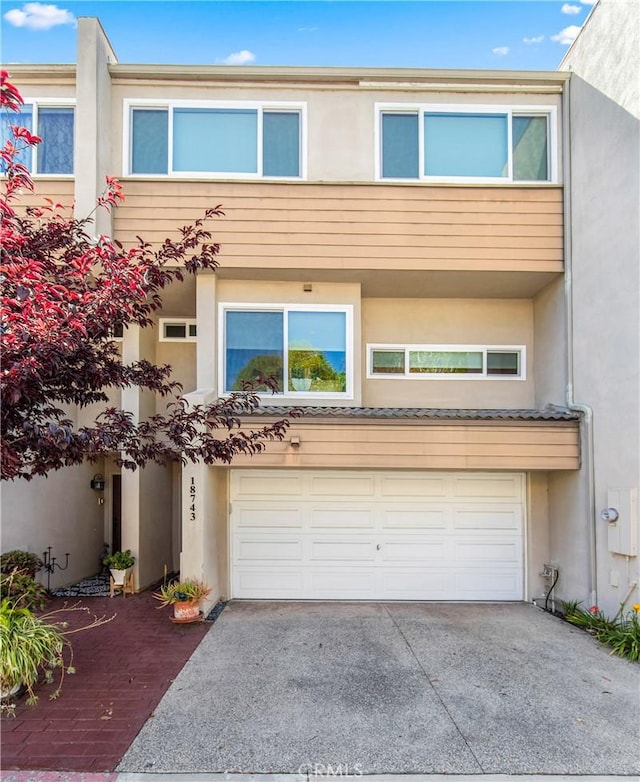 18743 Club Ln, Huntington Beach, CA 92648 - multi unit property featuring an attached garage, concrete driveway, and stucco siding