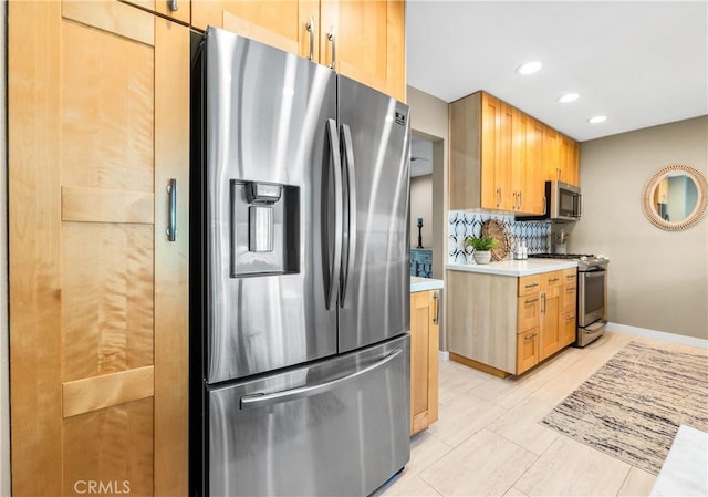 18743 Club Ln, Huntington Beach, CA 92648 - kitchen featuring stainless steel appliances, light countertops, backsplash, recessed lighting, and baseboards