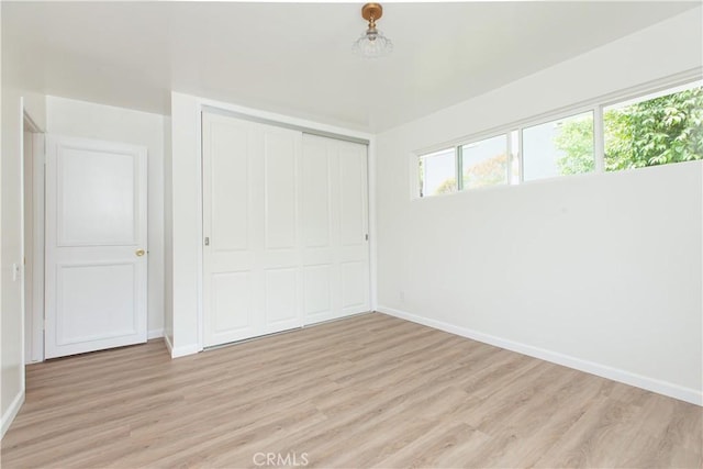 14879 Jadestone Dr, Sherman Oaks, CA 91403 - unfurnished bedroom with baseboards, light wood-type flooring, and a closet