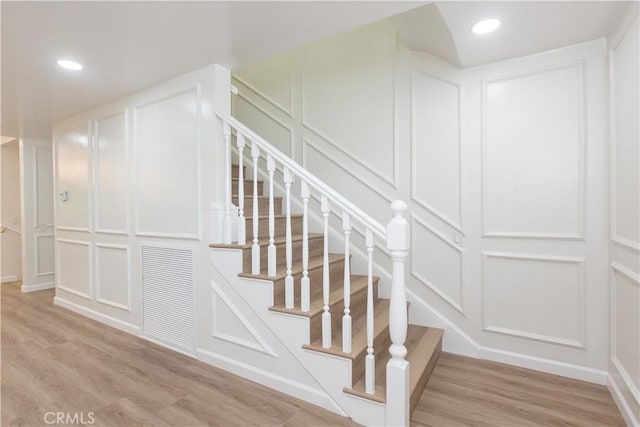 14879 Jadestone Dr, Sherman Oaks, CA 91403 - stairs with a decorative wall, wood finished floors, and recessed lighting