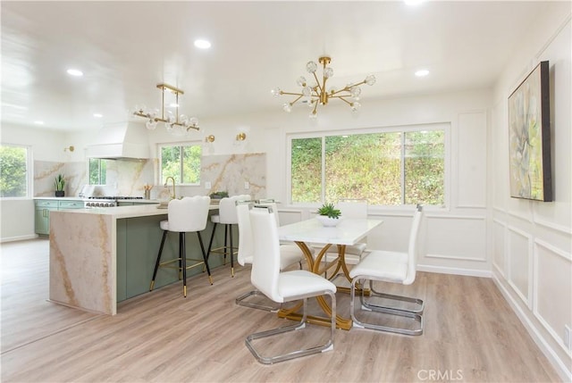 14879 Jadestone Dr, Sherman Oaks, CA 91403 - dining space featuring a chandelier, light wood-style flooring, recessed lighting, and a decorative wall