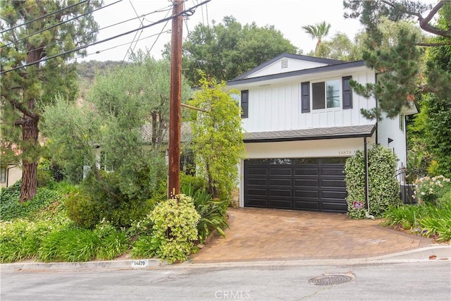 14879 Jadestone Dr, Sherman Oaks, CA 91403 - view of front of home featuring an attached garage, decorative driveway, and board and batten siding